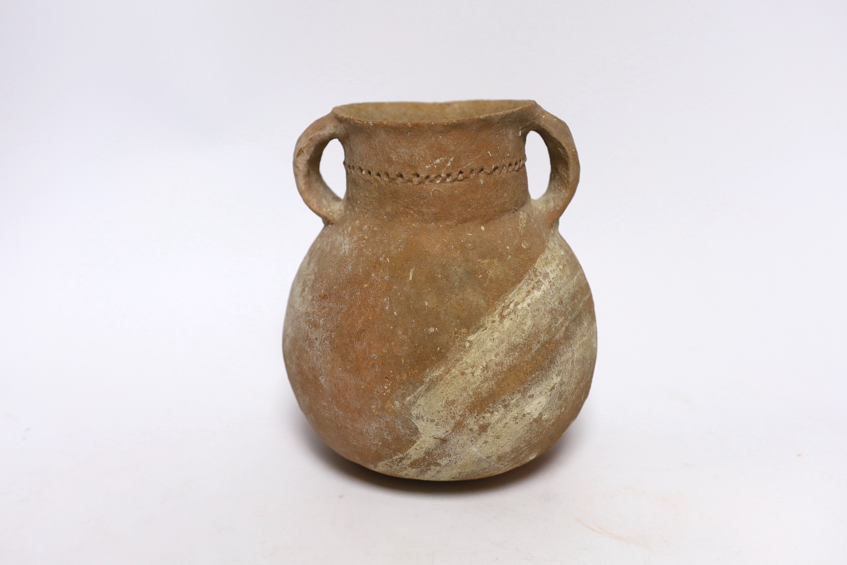An intact Roman terracotta two handled jar, 17.5cm high